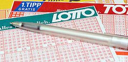 Choosing winning numbers in Austria Lotto, using blank playslip coupon.